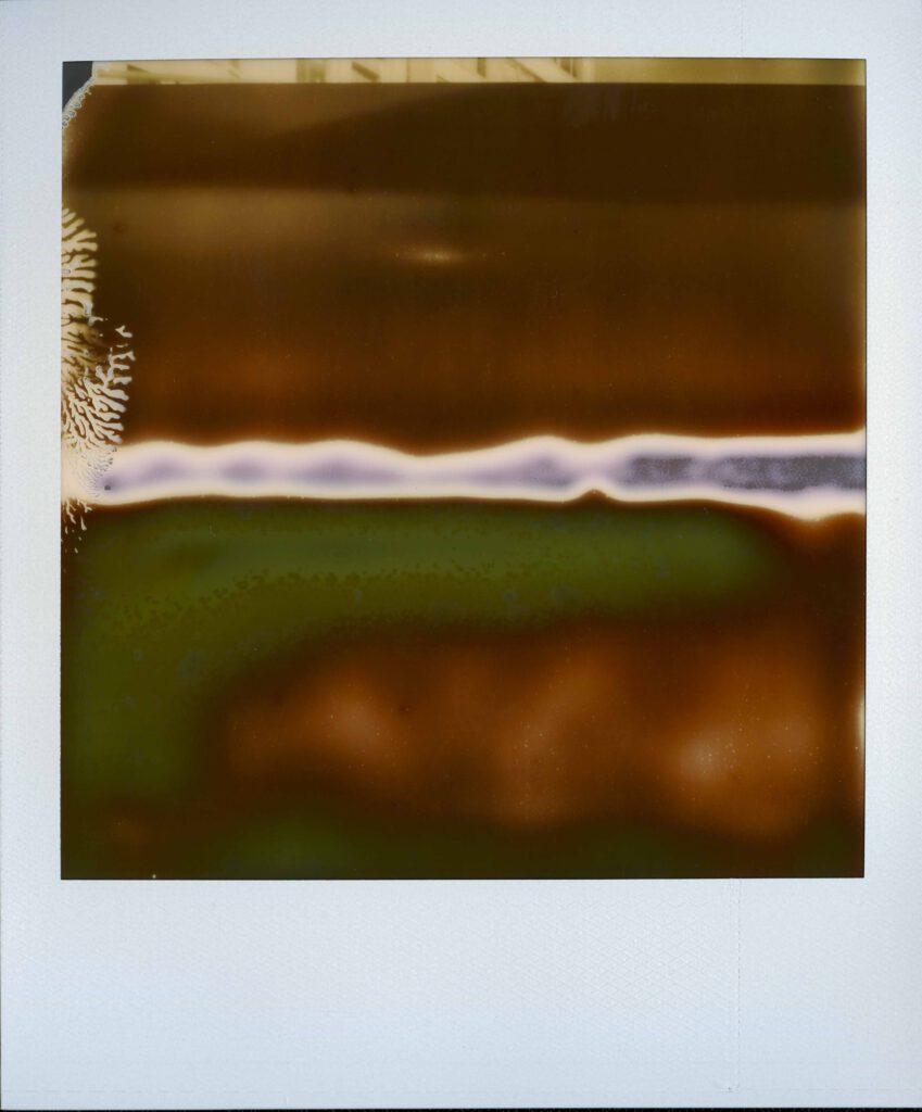 An old polaroid creating a small colourful abstract picture. Number 19 of the project