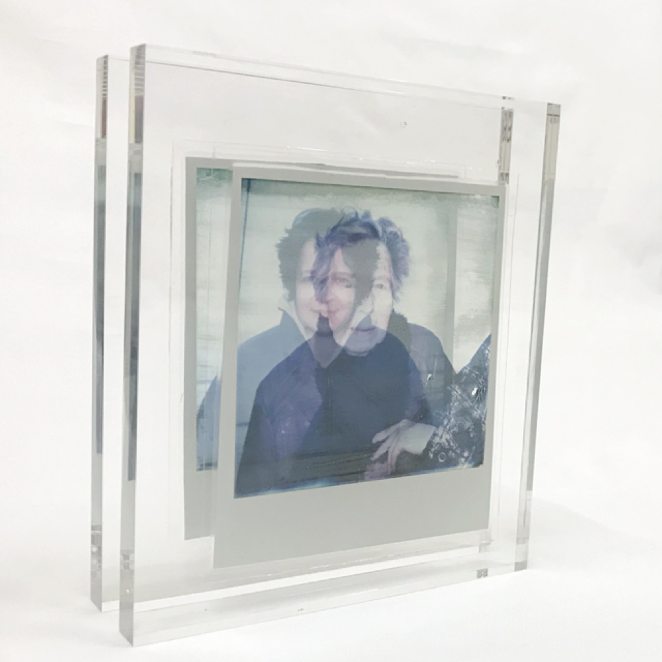 Polaroid Paradox this time two separate polaroids incased in acrylics of a grandmother and granddaughter. Shown from the side to reveal the space between the two.