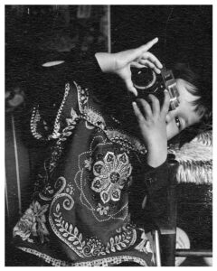 Portrait of the artist with camera around age 4
